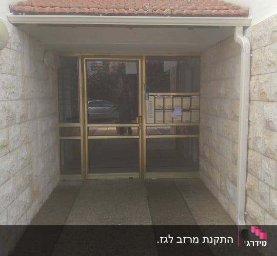 גג רעפים אדום מעל כניסה לבניין